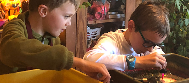 Two boys making spin art