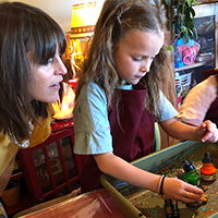 Mom watching daughter do spinart