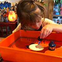 girl engrossed in spinart project